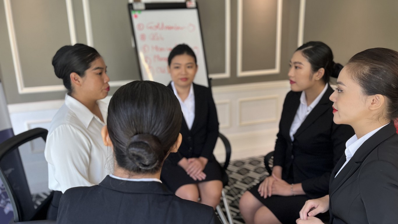 Small group of candidates in a seated discussion during assessment